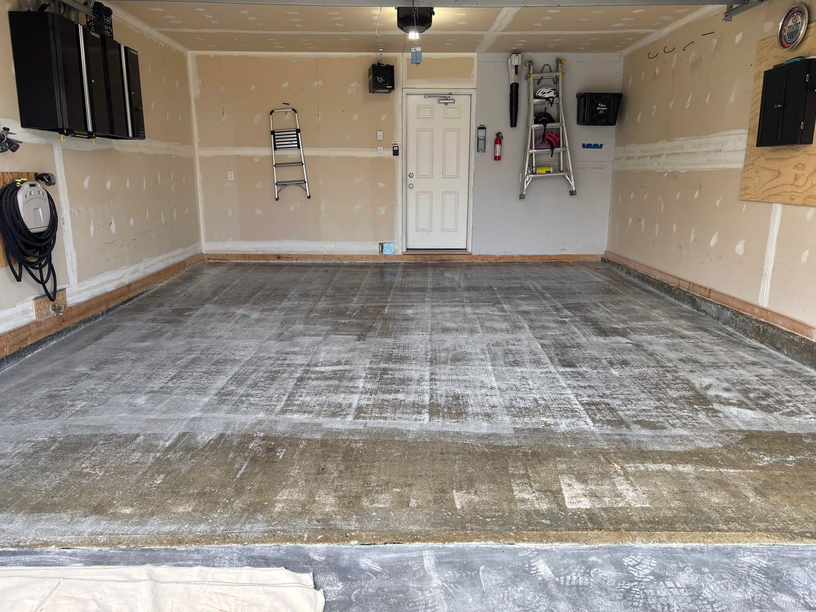 Before: bare concrete garage floor
